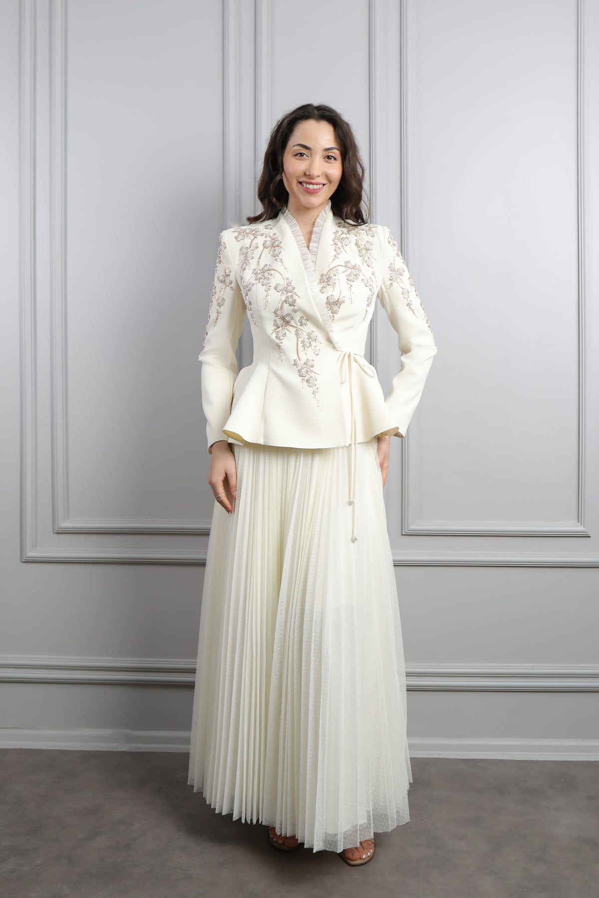 طقم تنورة بتكسيرات وجاكيت مزين بتطريزات خرزية وكشكشة -سكري