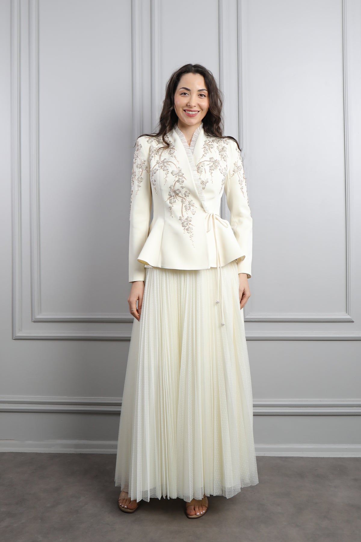 طقم تنورة بتكسيرات وجاكيت مزين بتطريزات خرزية وكشكشة -سكري